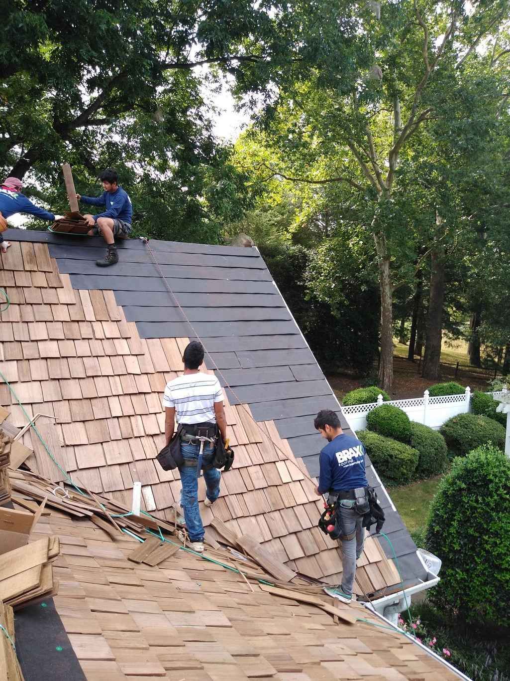Two roofers on a steep pitched roof